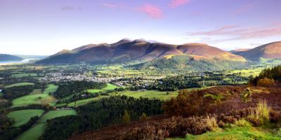 Pink skies over Keswick in the Lake District Pink skies over a countryside town surrounded by mountains and trees