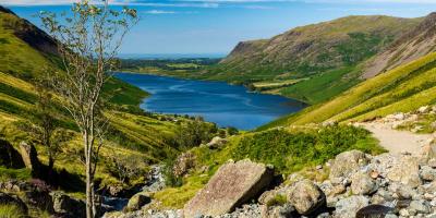 View from Scafell Pike Large blue lake surrounded by green rolling hills