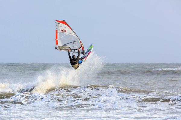 Windsurfer taking a jump, off Gower