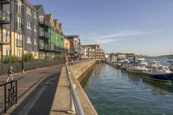 Littlehampton riverfront, with apartment houses and moored river cruisers