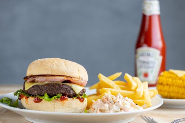 Burger, chips and coleslaw on a plate