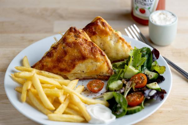 Toastie and chips on a plate with side salad