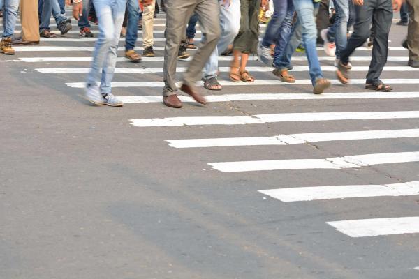 Groups of people walking across a street