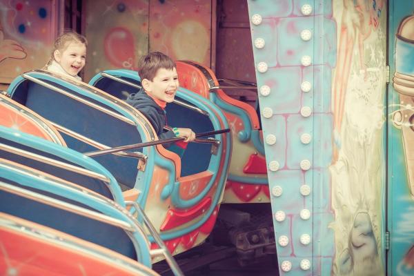 Children riding a rollercoaster at a theme park