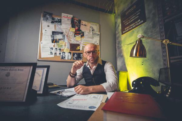 Man sitting at a desk wearing glasses