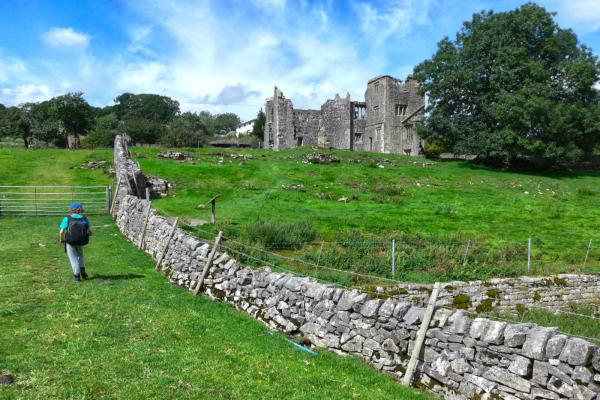 Child walking past a ruined building