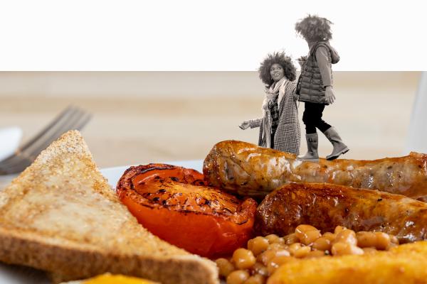 Child standing on top of a cooked breakfast