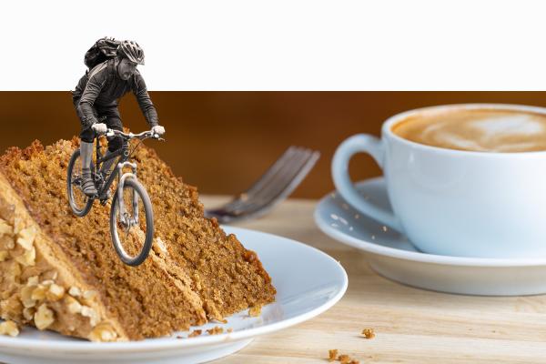 Creative hero image featuring a cyclist cycling down a piece of cake 