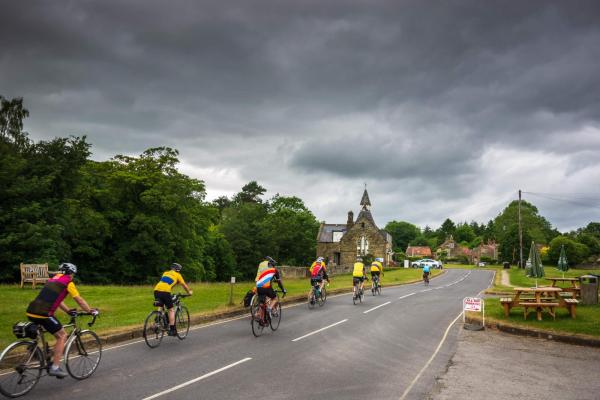 Cyclists in village in Yorkshire