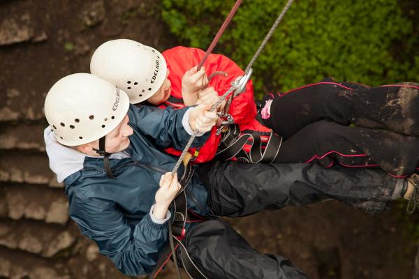 Young people abseiling at YHA Edale Activity Centre