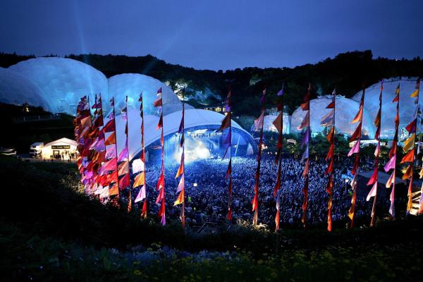 Outdoor stage in front of the Eden Project biomes at night