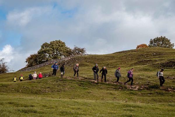 Group of people walking in countryside near YHA Hartington Hall