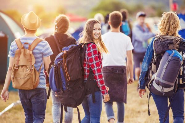 Group of young adults walking while wearing backpacks