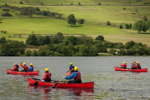 Group of young people canoeing at YHA Edale Activity Center 