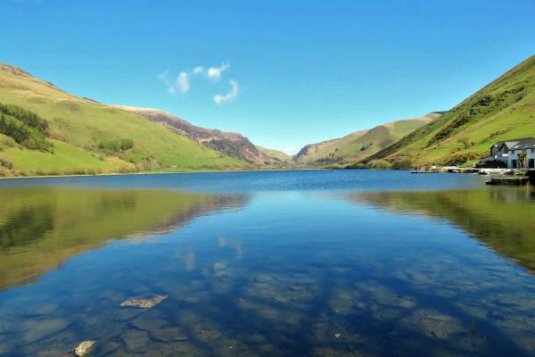 Large open lake surrounded by green hills