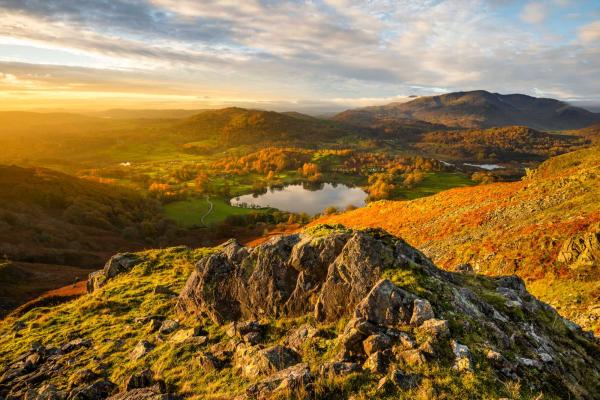 Rolling hills surrounding a lake at sunrise