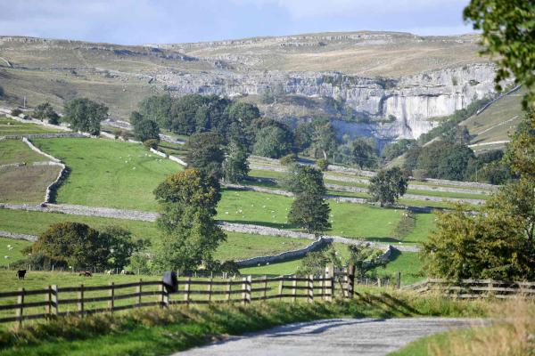 View over grass fields onto rolling hills