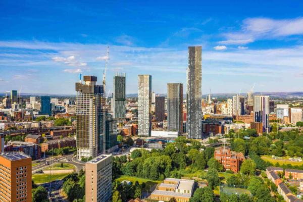 Skyline view of a large city with skyscraper buildings and blue skies