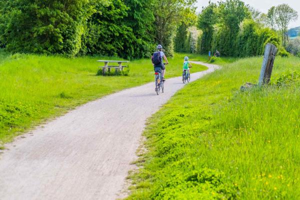 Mother and son cycling along a path in Stratford-upon-Avon