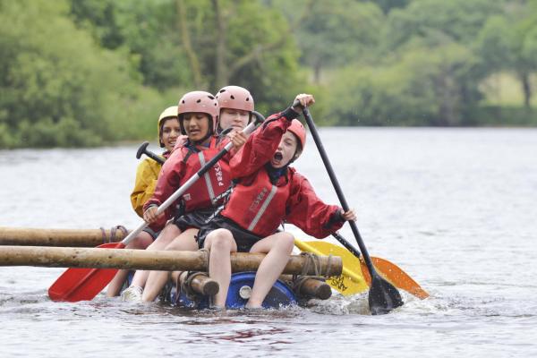 Group of female students steering a raft at YHA Edale