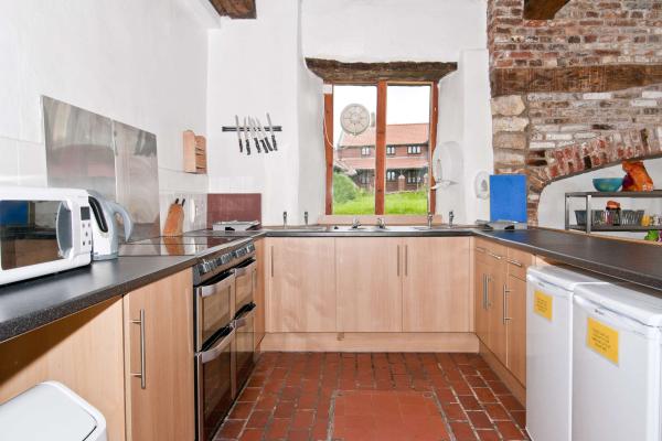 Kitchen with cabinets, oven and microwave