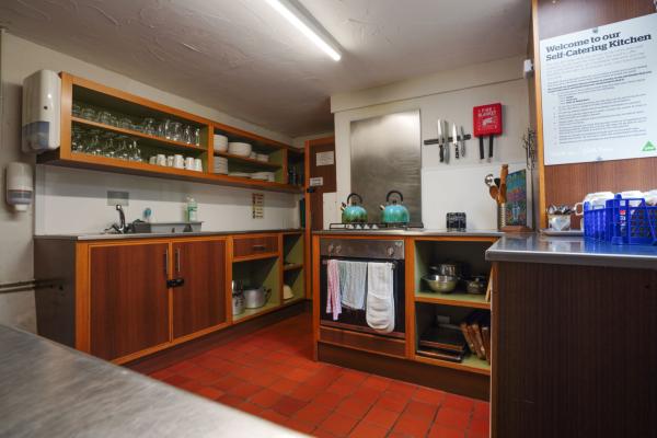 Kitchen with cabinets, oven and kettles