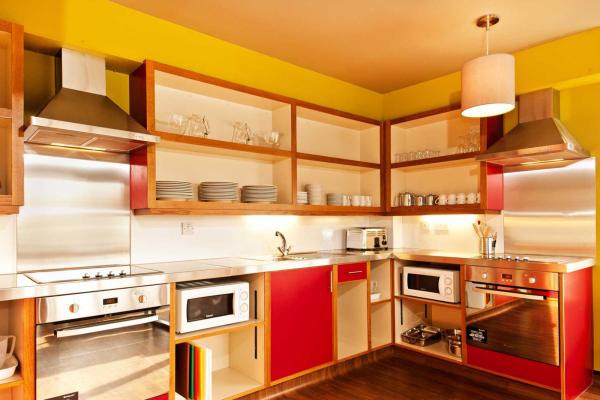 Kitchen with bright pink cabinets and crockery on display