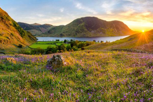 Sunset over rolling hills and a large lake