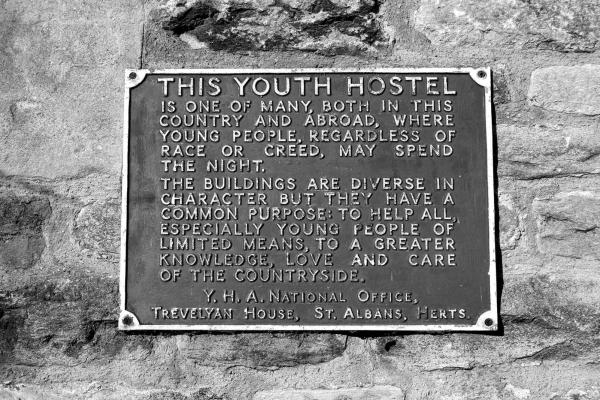 Black and white archive photo of a YHA wall plaque