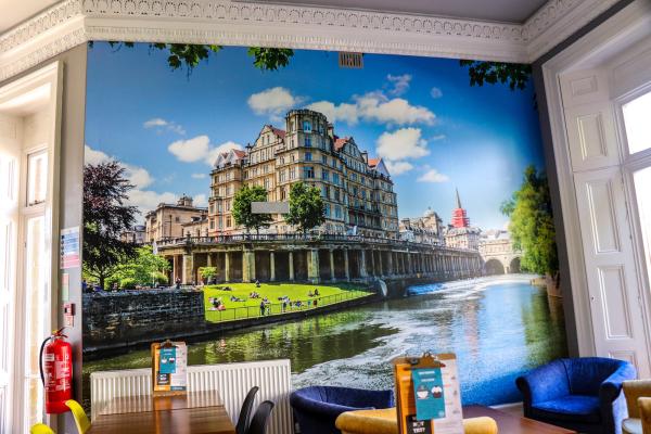 YHA Bath dining room with mural of Bath on the wall