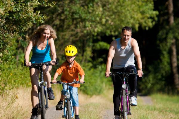 Family cycling in countryside