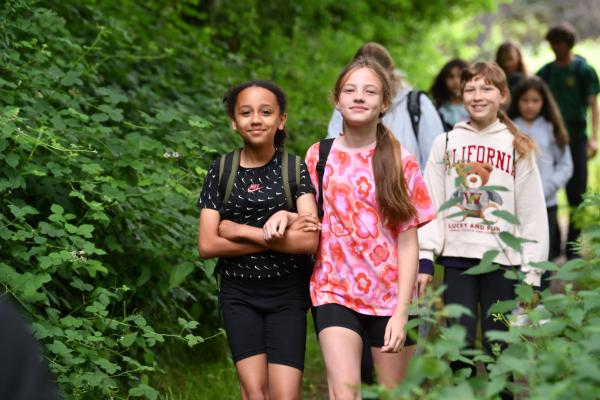 Group of children walking through woodland