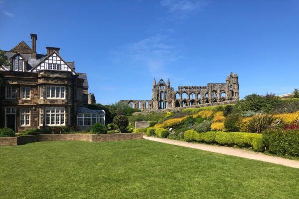 Hostel building of YHA Whitby next to Whitby Abbey ruins