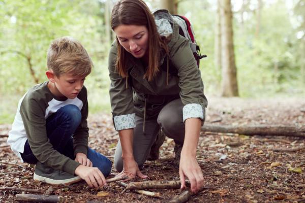 Group leader and child outdoors