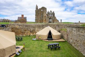 YHA Bell tent with the view of Whitby Abbey in the background