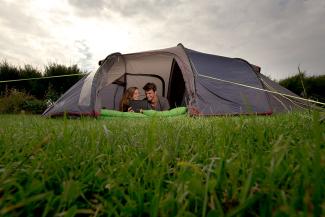 Two adults in a camping tent