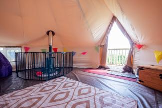 YHA Eden Project premium bell tent interior with log burner