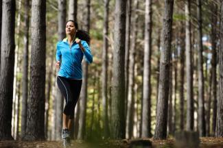 Woman running through trees