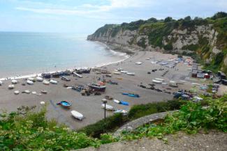 Large, open beach with parks boats and views out to the sea