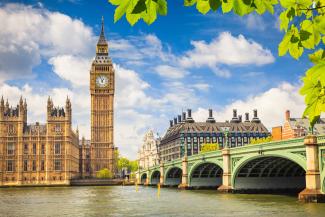 Clocktower of Big Ben and a green bridge over the river Thames