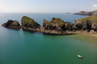 View of Pembrokeshire coast with boat on the water