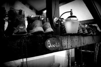 Black and white archive photo of a rack of walking boots