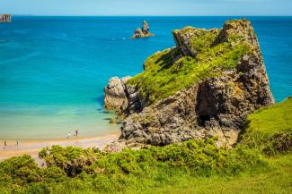 Mossy rock formations overlooking a blue ocean