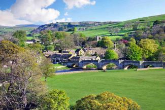 Pretty village surrounded by green fields and trees