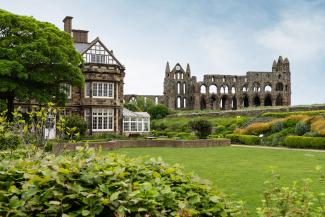 Exterior of YHA Whitby with Whitby Abbey in the background