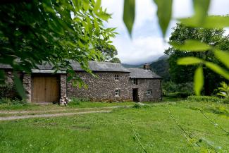 Stone camping barn surrounded by trees