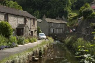 Small stream flowing past two houses