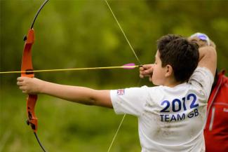 Child taking part in an archery activity