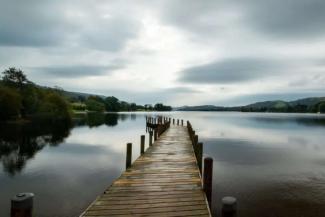 Wooden bridge leading out onto a lake