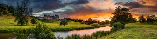 View over a river and fields at sunset